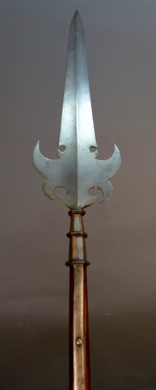 French Partisan, circa 1630: French partisan, possible dates to 1630. This double-bladed spearhead is mounted on a long shaft that had protrusions on either side for parrying sword thrusts. It has a fine broad crescent base w/ fo