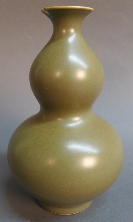 Chinese Double Guord Vase: Chinese green glazed porcelain double gourd vase. Chip on underside of top rim. Signature on bottom. Height: 7", Width: 4 1/4"