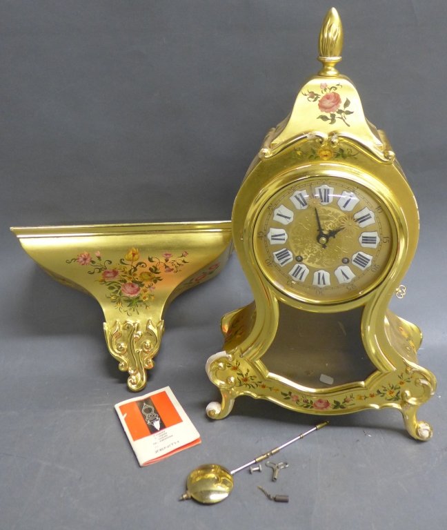 Zenith Backet Clock and Shelf: Zenith table clock in gilt and hand painted wooden case. Artist signed on back top: L. Herter. Accompanied by matching shelf bracket/ shelf. Height of Clock: 19", Width: 10 1/2" & Height of Shelf: 11