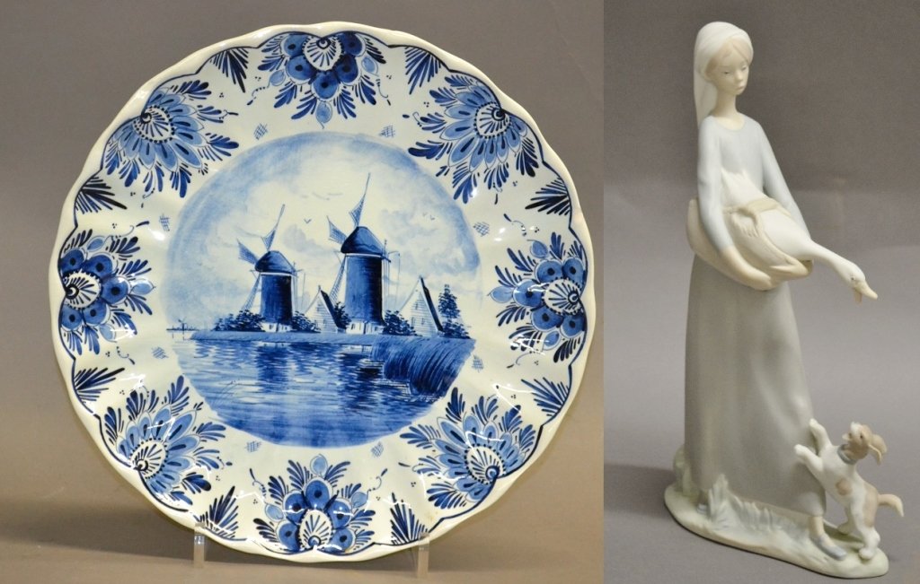 Lladro& Delft Blue Plate: Lladro Figurine. Girl with goose and dog. Height: 10 3/4", Width: 5 5/8". Delft Blue is the world-famous earthenware that has been produced in the city of Delft since the 17th century. This hand paint