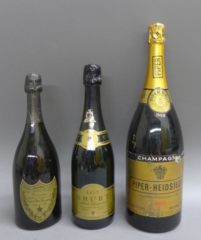 Group of Vintage Champagnes: Group of vintage Champagnes. Sealed bottles include: Piper- Heidsieck Brut, Gruet Brut, & Dom Perignon 1976. Height of Piper:15 1/2", Width: 4 1/2", Height of Gruet: 12 1/2", Width: 3 1/2" & Height of