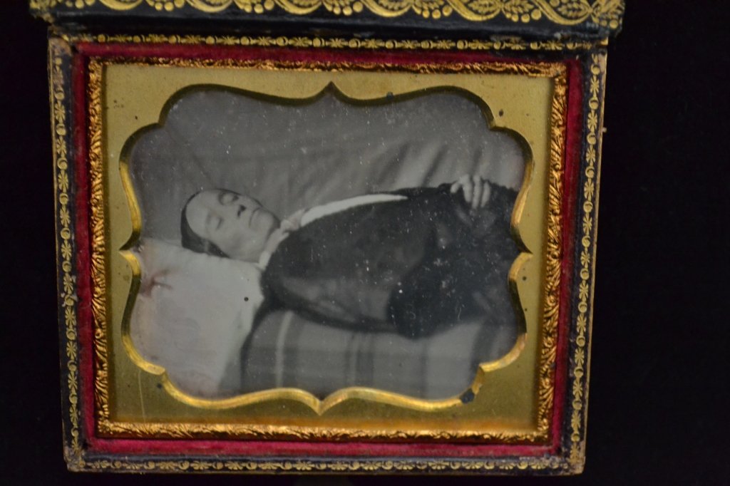 Victorian Post Mortem Ambrotype/ Daguerreotype: From the Estate of Mark Falk. Sixth plate Ambrotype/ Daguerreotype of a lady, possibly about 40 years old. Shown from the waist upward, lying on a blanket and pillow, with her face turned slightly tow