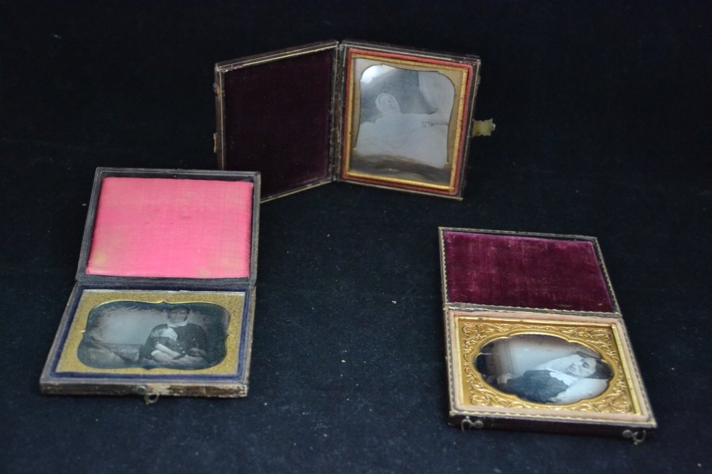 Victorian Post Mortem Ambrotype/ Daguerreotype: From the Estate of Mark Falk. Collection of 3 sixth plate Ambrotype/ Daguerreotypes. All have gold mats. 2 cases have velvet pillows and the 3rd has a satin pillow. The Daguerreotype with the satin pi