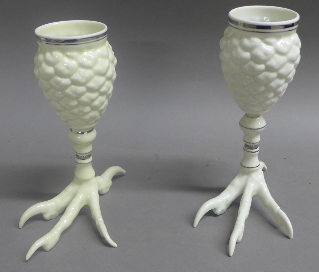 Pair Goblets: From the Estate of Mark Falk. Pair of unique porcelain goblets. The pinecone shaped cup is supported by a bird's talon. Silvered banding on cup and stem. Maker's mark on bottom. Height: 7 1/2", Width: