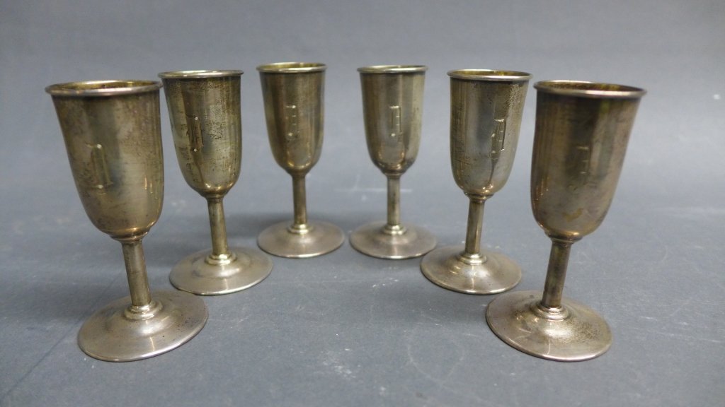 Set of 6 Sterling Silver Cordial Aperitif Glasses: From the Estate of Mark Falk. Set of 6 sterling silver cordial aperitif glasses/ goblets with engraved monogram "D". In fitted case. Approx total weight 89 grams. Height of glasses: 3"