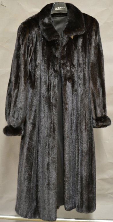 Long Fur Coat: Black/ brown fur coat, possibly genuine mink. Top button hook needs re-sewing. Initials embroidered into inside lining. Great condition. Length: 52"