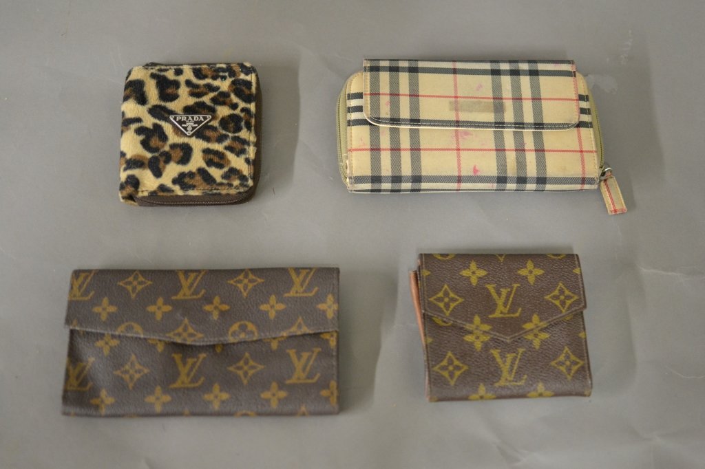 Designer Wallets: Collection of 4 wallets. Wallets are possibly genuine Louis Vuitton, Prada and Burberry. Some rips, tears, and discoloration. Length of Largest: 7", Width: 4"