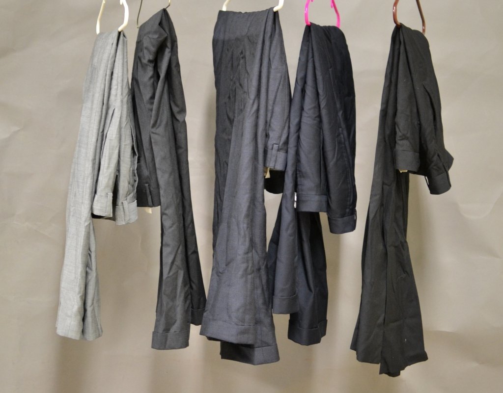5 Pairs of Suit Pants: Assortment of suit pants, varying colors, sizes and styles. 1 light gray, 1 dark gray, 1 woven navy, 1 solid navy and 1 black. Few marks, stains and loose threads. Designers include: Hugo Boss and Zan