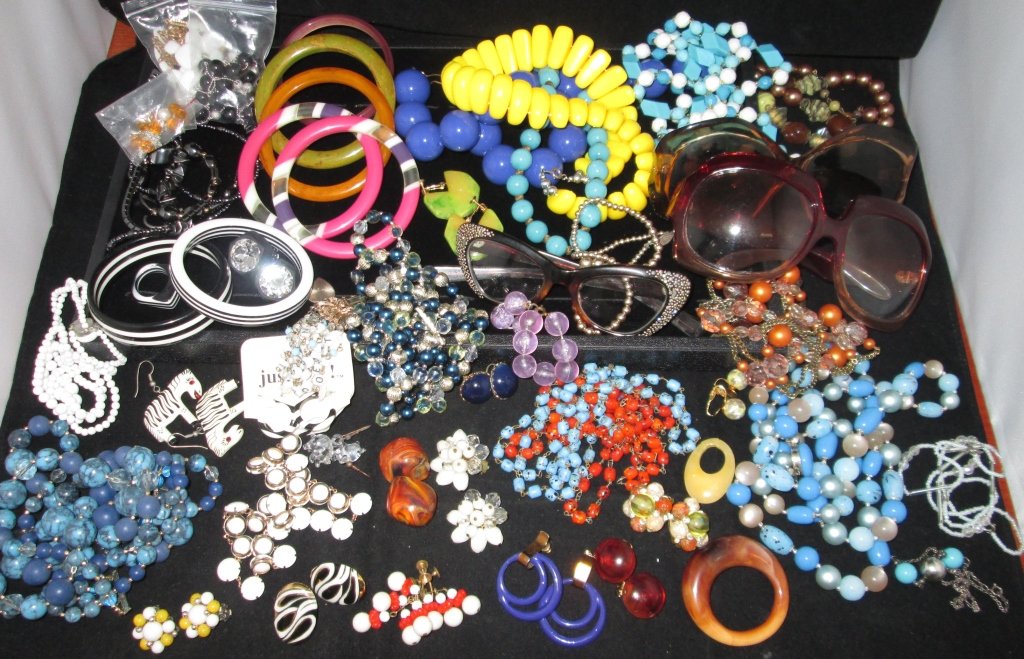 Collection of Jewelry: Large array of 80's style colorful jewelry and sunglasses. Collection includes earrings for pierced and non-pierced ears, necklaces, bracelets, and bangles.