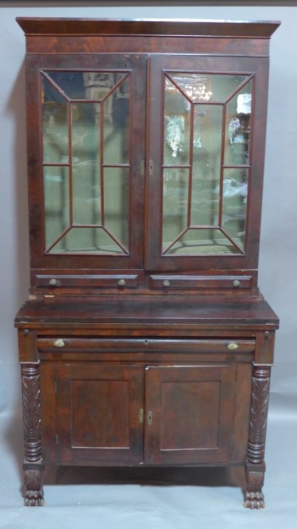 Empire Style Secretary Breakfront, 19th C: Antique mahogany breakfront cabinet with glass panel cabinet doors glass doors surmounting a lower chest and bear claw feet. Height: 76", Width: 39 1/2", Depth: 20 3/4"