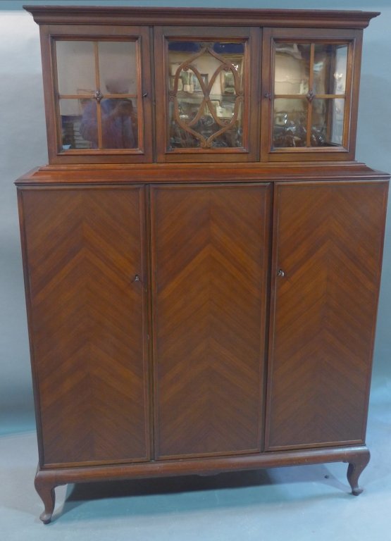 Breakfront, Continental: Continental mahogany break front. Glass shelf in top section. Missing center wood medallion on top center door. Height: 75", Width: 51 1/2", Depth: 16"
