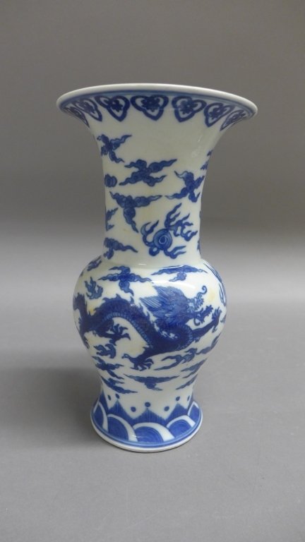 Blue and White Dragon Vase: Chinese blue and white dragon vase. Hair line crack to flared top rim. Maker's mark on bottom. Height: 10", Width: 4 1/2"