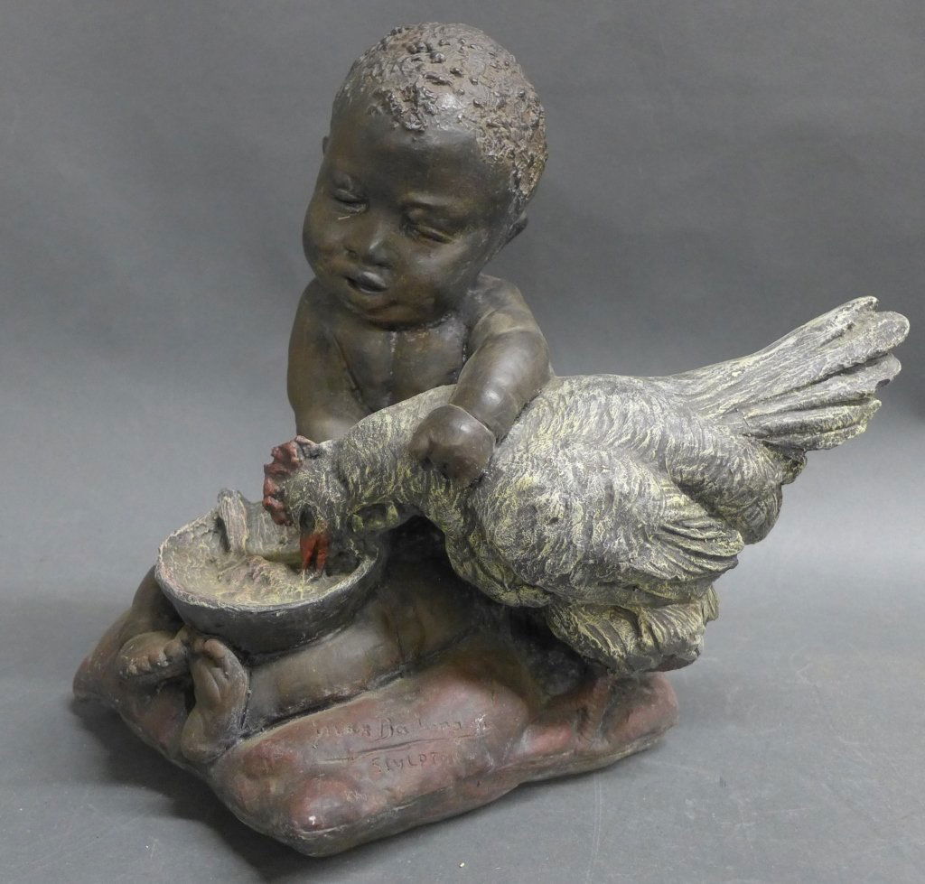 Ma Bachmann Sculpture: Max Bachmann, American (1862-1921) Resin sculpture of a boy and a rooster. Signed: Max Bachmann Sculptor 1902 on front of pillow and on the back of the pillow: Copyright by Max Bachmann 1902. Height: