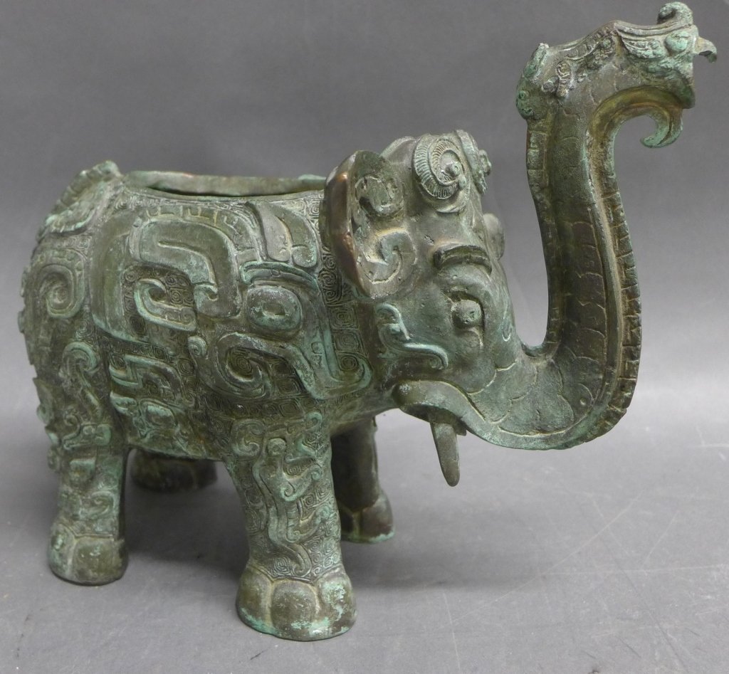 Asian Bronze Elephant: Patinated bronze elephant sculpture/ pitcher in the style of the Shang Dynasty. Height: 8 1/2", Width: 9 1/2"