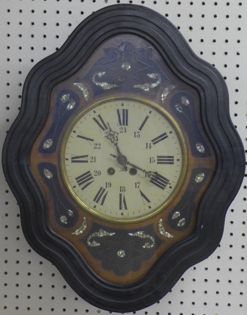Antique French Vineyard Wall Clock: Old French Wall clock. Mother of pearl inlay and curving symmetrical scalloped wood frame. In overall good condition with age appropriate wear and some cracks on outer wood frame. Height: 24", Width: