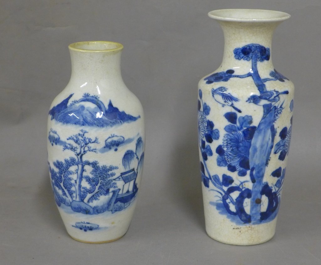 Asian Blue & White Vases: Porcelain vases with painted iconic Asian images and scenes. Crazing on both pieces. Some nicks and chips on rim. No noticeable maker's marks. Height: 10", Width: 4"