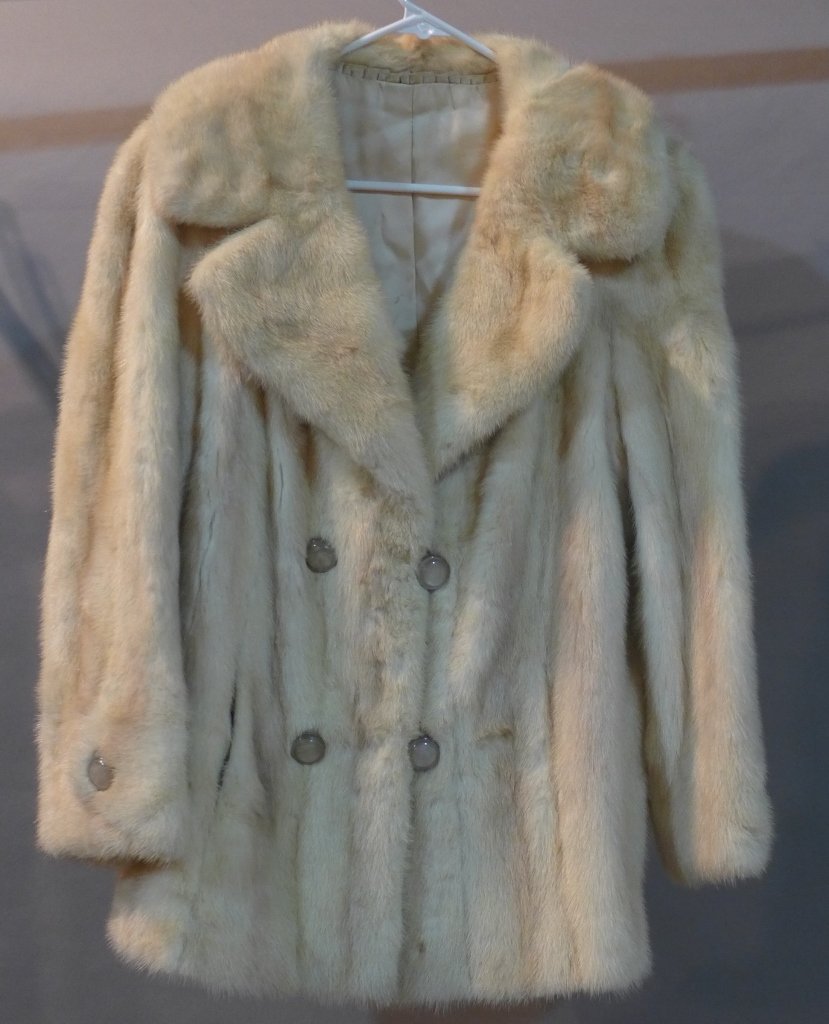 Fur Coat: Vintage white/ light tan fur coat. There are openings in the seams on either side of the jacket to allow a decorative back strap to hook on. The opening on the right is split open 6" and the left side