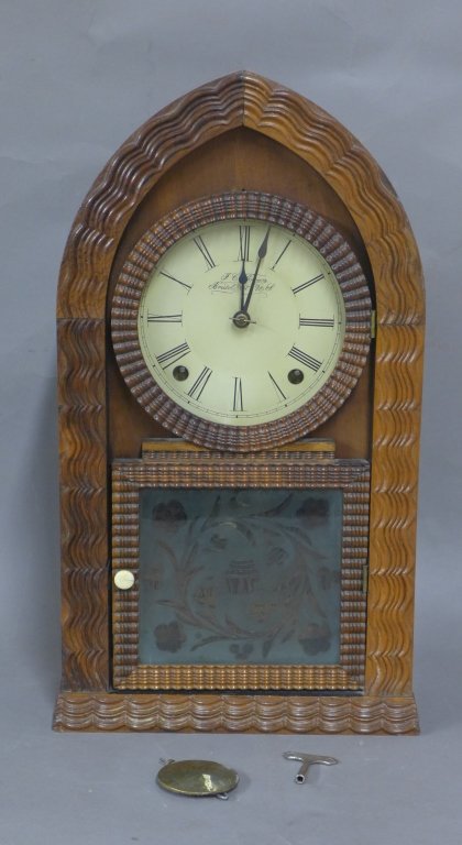 J.C. Brown Ripple Front Beehive Clock: Steeple ripple front beehive shelf clock by J.C. Brown, Bristol Connecticut. 8 day time with hourly gong strike. Has decorative ripple molding on the front. Case is in excellent condition. Original fr