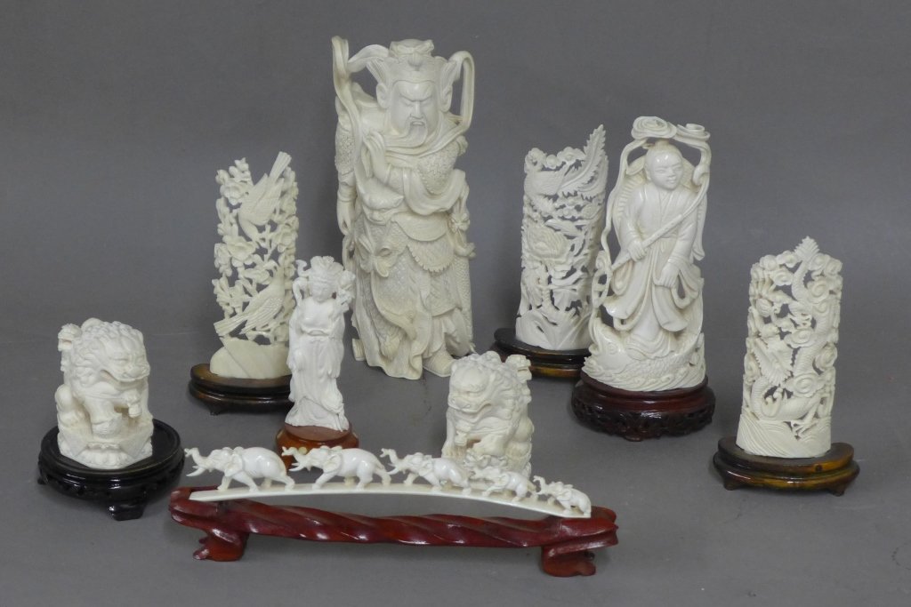 Vintage Carved Ivory Sculptures: Collection of 9 hand carved Asian ivory sculptures on wood bases. 3 Figures, 2 foo lion/ dogs, 1 parade of elephants, and 3 carved towers with birds, dragons, and flowers. In great condition, no visib