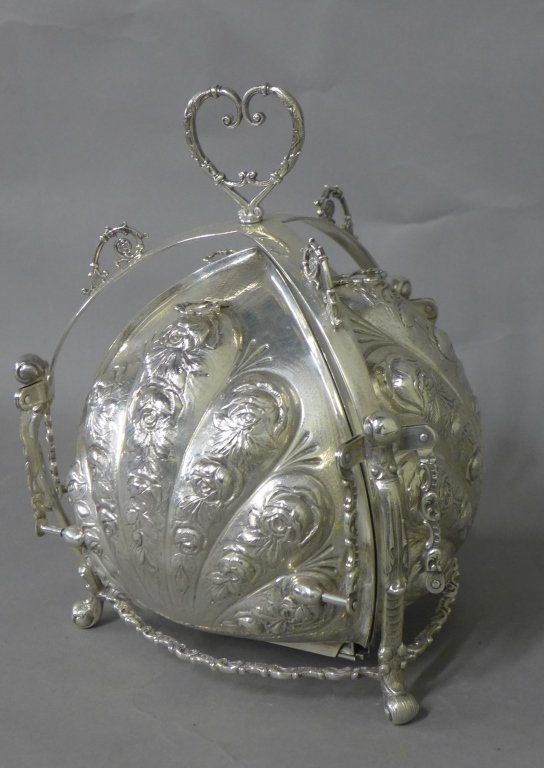 Sterling Silver Tri-Fold Bun Warmer: Stunning sterling silver bread warmer with 3 hinged compartments. Ornate chased and repousse design of roses. Maker's marks on bottom. Stamped: Sterling, J.V.H, G.E.S.G, Germany. Height: 9 3/4", Width