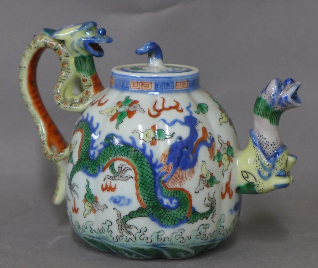Hand Painted Japanese Porcelain Tea Pot: Asian art Pottery. Maker\'s marks on tea pot rim and lid. Signed on bottom. In great condition with no noticeable damage. Beautifully painted in bright colors on white ground. Sculpted and painted dra