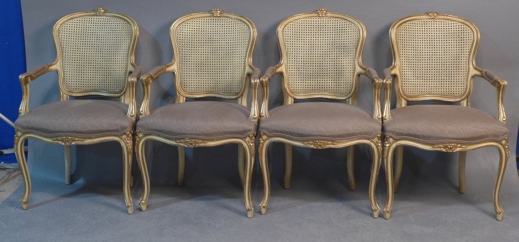 Louis XV Arm Chairs: Grouping of 4 Louis XV style arm chairs with caned backs and upholstered seats. Some wear to gilding, slight chipping. Height: 37 1/2", Width: 23", Depth: 19" (furniture, seat, seating, cabriole leg, 