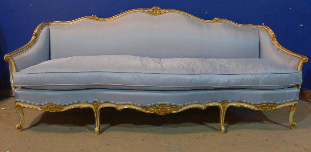 Louis XV Style Sofa / Large Settee: Blue upholstered sofa / large settee with painted nd gilt wood frame. Fabric tag reads: W & J Sloane Inc. Established 1843. Discoloration on back rest. Some pulls on front of sofa. Tears to fabric on 