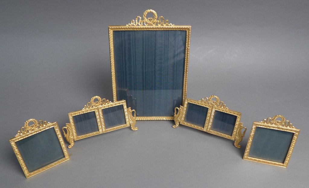 Assortment of Gilt Picture Frames: Collection of 5 dore over bronze picture frames. Varying sizes. All are decorated with ribbon, wreath and a bow on top. The two double frames have swans on either side. Picture Sizes: Height: 8 1/2", 