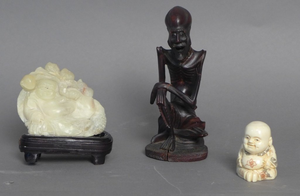 Collection of Three Carved Figures: Collection includes small dimpled ivory Buddha, relaxing soapstone Buddha on base and a laughing wooden thin man. Some repairs & imperfections. Height: 6", Width: 2 1/2", Depth: 2 1/2". (Asian, Orient