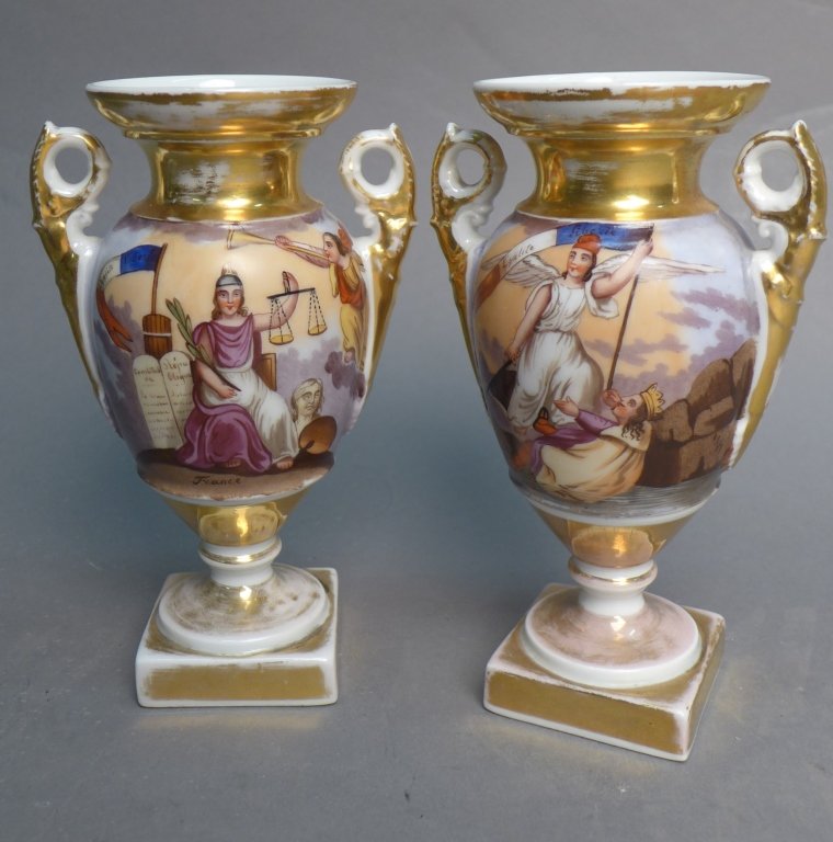 Pair of Gilt and Painted Porcelain Urns: Pair of hand painted and gilt double handled French urns. Depicts Justice, Liberty and other French symbolism. Some wear. Height: 6 3/4", Width: 4", Depth: 3" (sculpture, art pottery, ceramic, clay, b