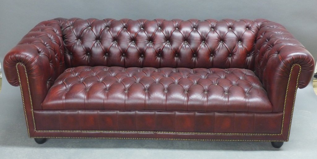 Chesterfield Leather Sofa: Red leather tufted Chesterfield sofa couch with nail head trim. No visible damage (no rips, tears or old restorations). Minor wear to leather. Height: 28", Width: 72 1/2", Depth: 33"STERLING ASSOCIATE