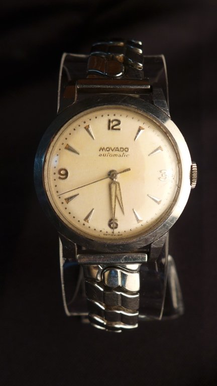 Vintage 1950's Movado Automatic Watch: Vintage 1950's Movado Automatic Watch. Engraved back reads "R.J.C. 1956" Stainless. Spring/strech band.Imperfections. Folded length: 3". Face size: 1 1/8" STERLING ASSOCIATES STRIVES TO PROVIDE ACCURA