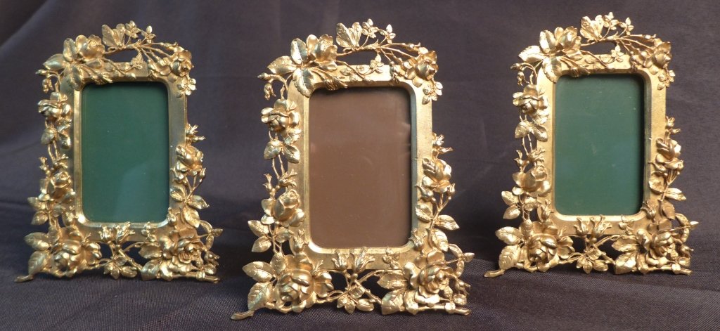 Set of 3 Gilt Picture Frames: Collection of 3 dore over bronze picture frames. Frame is decorated with roses and a butterfly sits on the top stem. Imperfections. Height: 5 3/4",Width: 4 3/4" & Image Size: Height: 3 1/4", Width: 2"