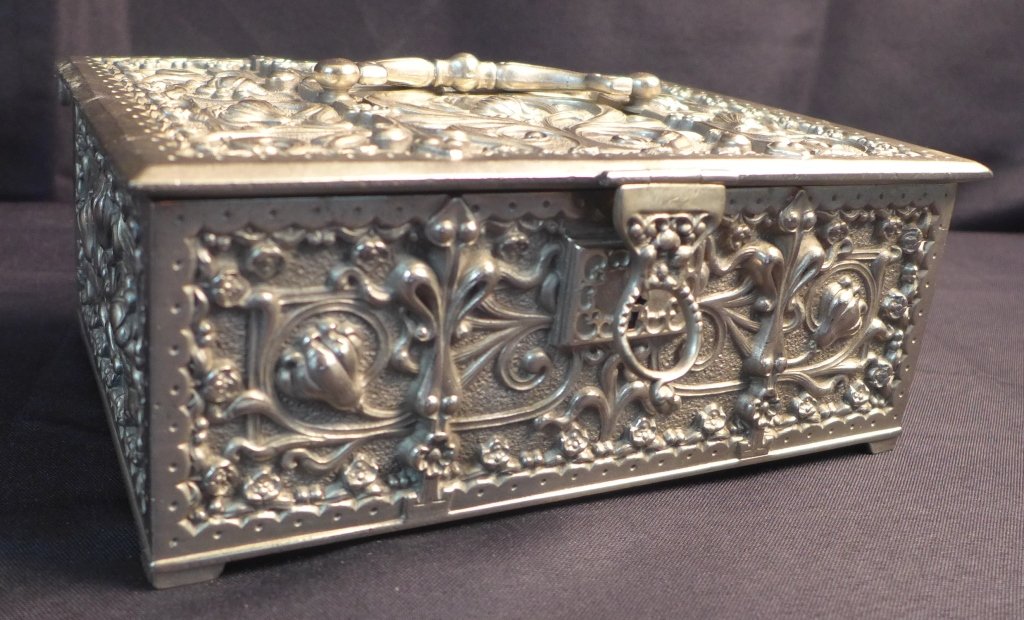 Silvered Bronze Lined Box: Silvered bronze box with a green velvet lining. Box is intricately decorated with flowing vines and flowers.(Continental, Gothic, Renaissance Revival)Height: 3 1/2", Width: 9", Depth: 6" STERLING ASSO