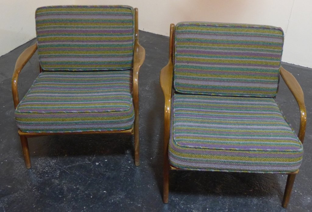 Pair of Danish Modern Lounge Chairs: Matching pair of Danish walnut chairs with upholstered cushions. Beautiful minimalist design with upholstered cushions in cool greens, blues and purple tones. Stamped "26 W Made in Denmark". Imperfect