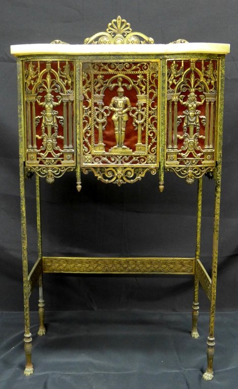 Bronze & Iron Telephone Console: In the manner of Oscar Bach, period brass and iron telephone console with three-door cabinet and white marble top. Maker's mark stamped under marble. The front and side brass panels are decorated with