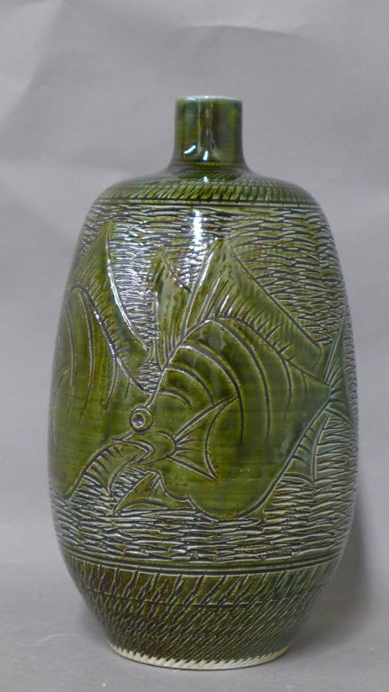 Japanese Green Glazed Vase: Asian art pottery. Ceramic vessel with carved linear fish and under water design. In great condition with no noticeable damage. Maker's mark on bottom. Height: 11", Width: 5 1/2" (Modern, mid century,