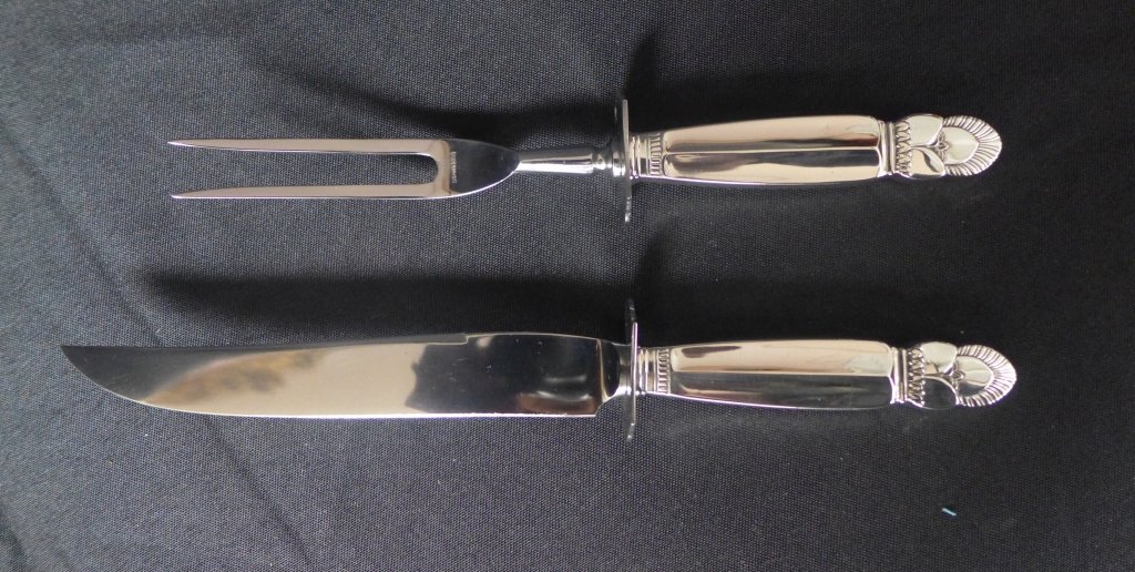 Sterling Silver Serving Utensils: Beautiful sterling silver fork and knife serving set with art deco style handles. Blade and fork marked: Stainless Steel. Handles have hallmark and are marked Sterling. Length of knife: 10 3/4" (moder