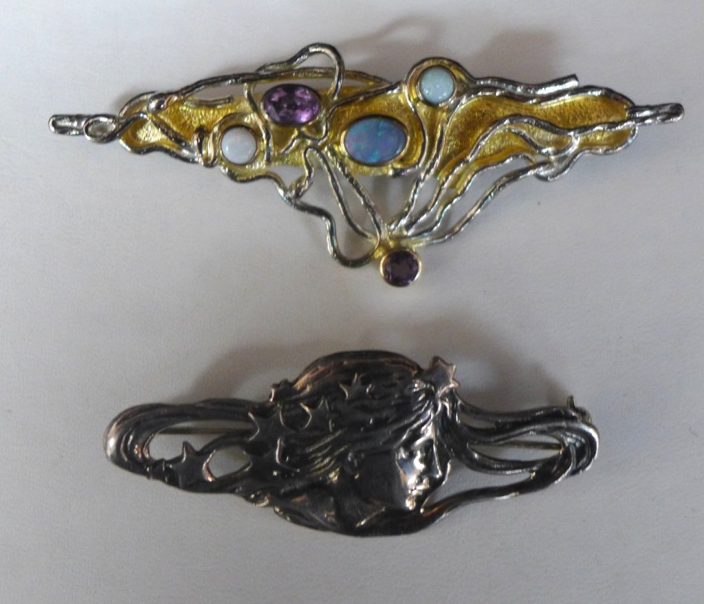 Sterling Silver Brooches: 2 sterling silver brooches. Artfully crafted sterling silver wire design pin with 5 bezel set gemstones on textured back plate. The other figural pin depicts a woman's profile with long flowing hair a