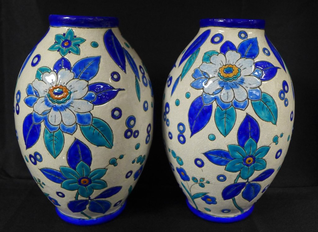 Charles Catteau, Pair of Art Deco Vases: Pair of Art Deco vases by Boch Freres designed by Charles Catteau at Atelier de Fantasie. Vases depict a stylized floral patternn in orange, aqua and blue on a white background using crackled enamels