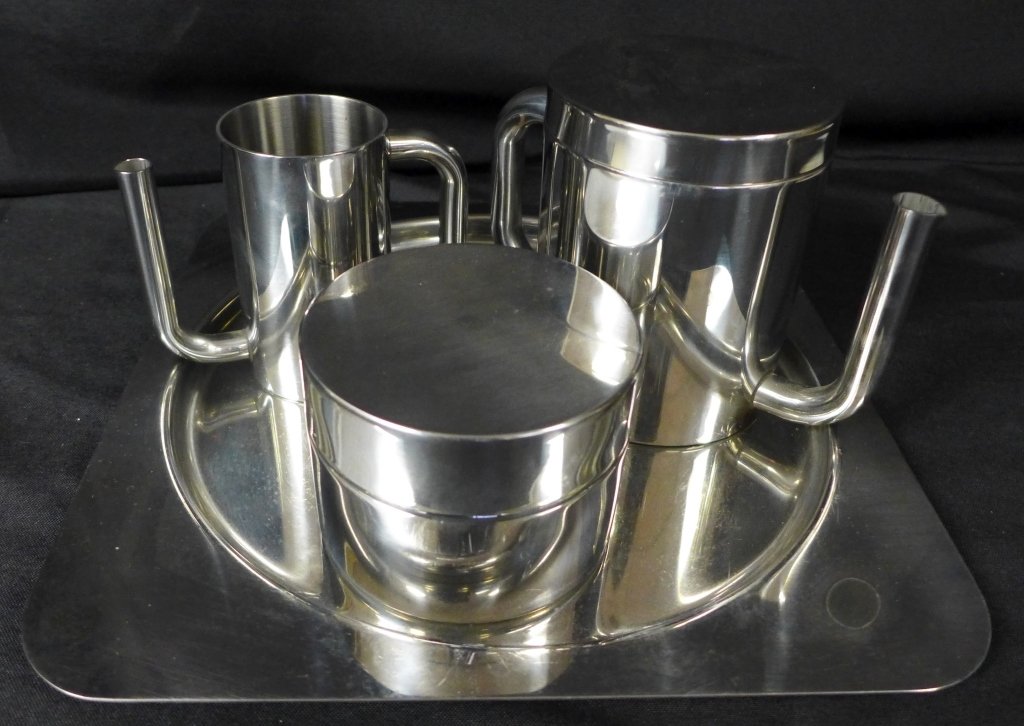 Modern Italian Metal Coffee Service: This stainless steel tea/ coffee serving set has a beautiful simplistic modern design. Service includes 4 pieces: creamer, tray, lidded sugar container & lidded coffee/ tea pot. Maker's mark on bottom