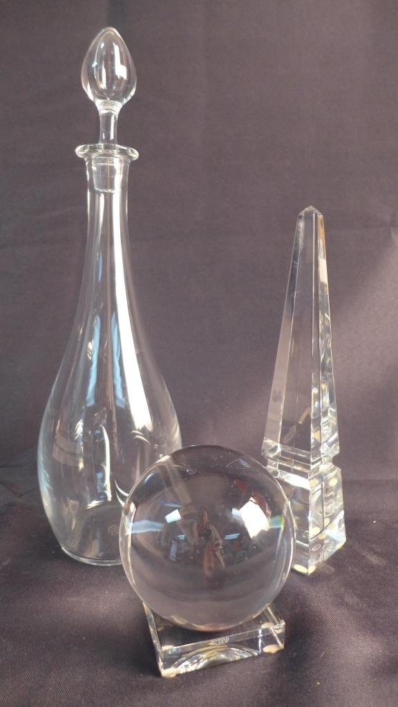 Collection of Baccarat Crystal: Grouping of French Baccarat crystal. Assortment includes 1 obelisk, 1 sphere with base & 1 decanter with stopper. All have Baccart hallmark on bottom. Obelisk is signed Baccarat on lower edge as well.
