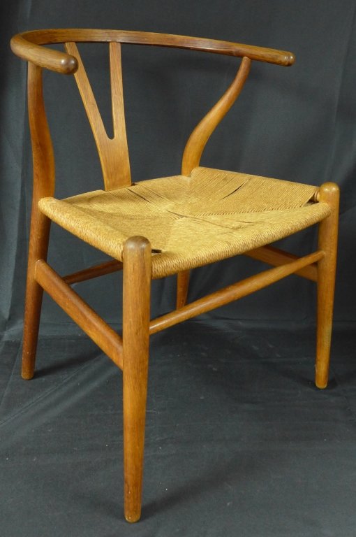 Carl Hansen Wishbone Chair: The Wishbone (Y) chair by Carl Hansen & Son, circa 1950. Wood frame with trapezoid rush/ papercord seat (old repair to rush). Maker's mark burned into bottom of chair. Height: 28 3/4", Width: 20 1/4",