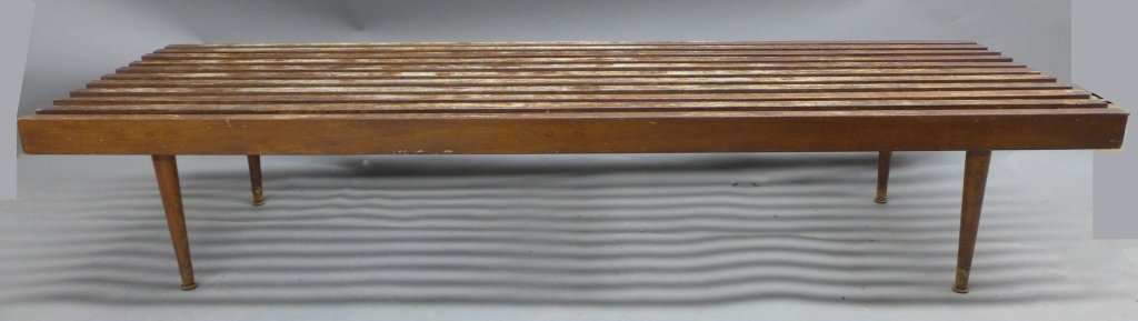 George Nelson Style Slat Coffee Table: Long George Nelson style slat coffee table. Modern, mid century sleek design. Metal caps on feet. Tapered legs. Imperfections and wear to wood. Height: 14 1/2"; Width: 72"; Depth: 22 1/4"(modern, mid 