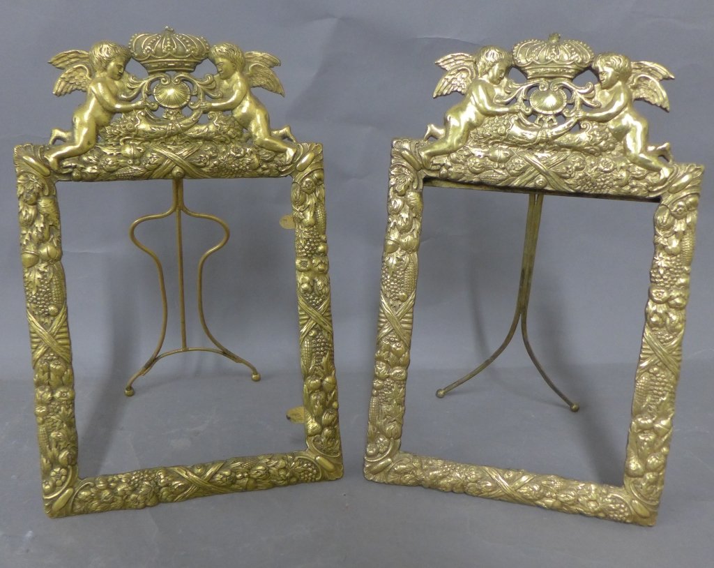 Dore over Bronze Figural Picture Frames: Pair of antique dore over bronze picture frames. Both ornate frames have repousse and chasing design a crown, shell and cornucopias between two winged cherubs above ribbons, fruit, vegetables and nuts
