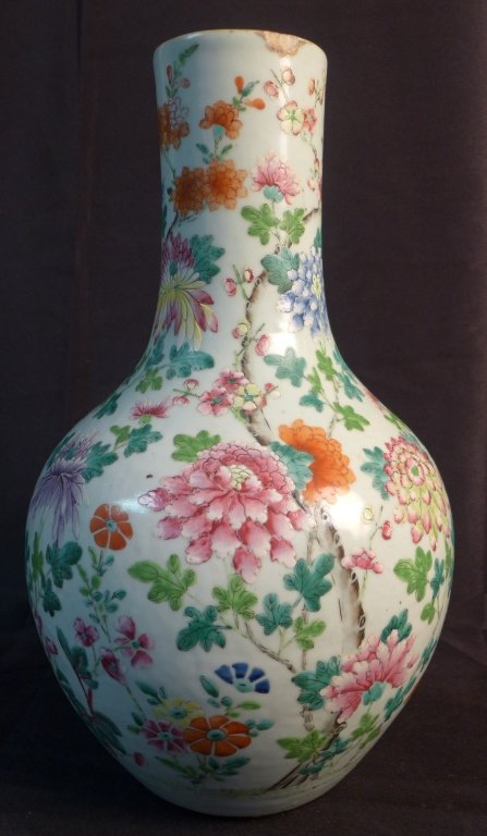 Chinese Famille Rose Vase w/ Flower Pattern: Stunning antique Asian bottle form porcelain vase. Hand painted floral design. Drilled as lamp. Signed China on bottom. Chip at top rim. Height: 17", Width: 10", Depth: 10" (Japanese, Asian, Oriental,