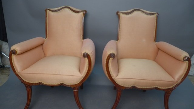 Upholstered Wing Armchairs: Pair unique upholstered armchairs with carved wood frames. Some discoloration to fabric and wear to wood frames. No noticeable maker's marks. Height: 42", Width: 28", Depth: 21"(seating, antique, vint