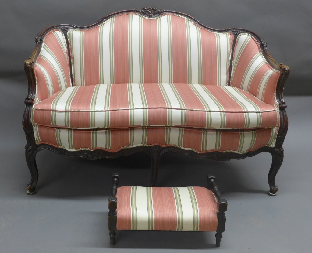 Carved Wood Settee with Foot Stool: Settee with matching stool has a carved wood frame and striped multi-color fabric . Minor wear and imperfections.Height: 35"; Width: 49"; Depth: 27". STERLING ASSOCIATES STRIVES TO PROVIDE ACCURATE, O