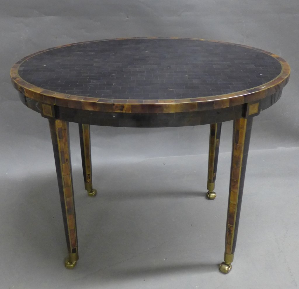Vintage Maitland Smith Tortoise Shell Table: Tessellated tortoise shell and possible fossil stone oval rolling side table with brass inlay made by Maitland Smith. Stamped with brass plaque: "Designed & handmade in Cebu, Philippines by Maitiand S