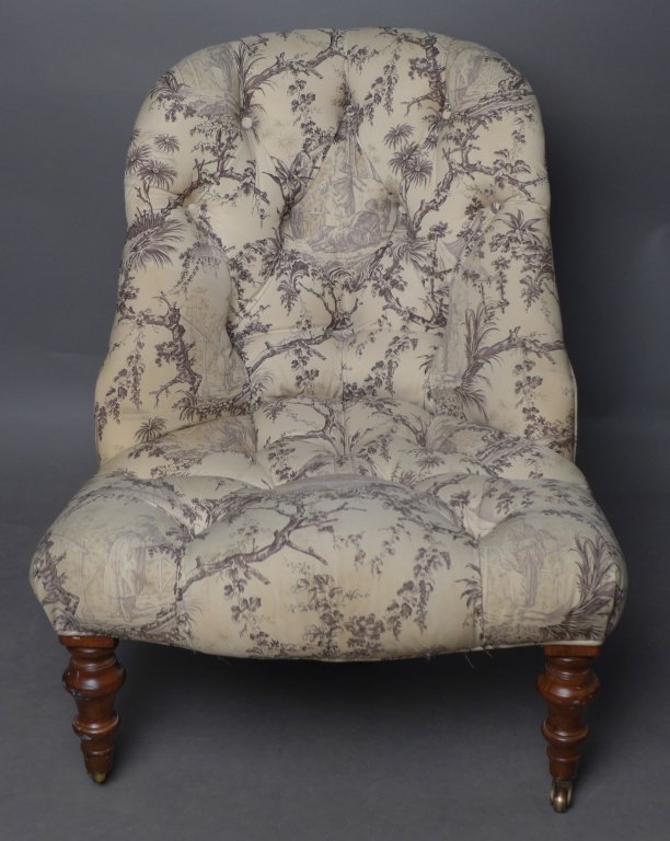 Tufted Slipper Chair: Small upholstered tufted chair with carved wood legs. Fabric pattern has figural landscape vignette designs. 1 noticeable hole, some discoloration to fabric and wear to wood legs. No noticeable maker'